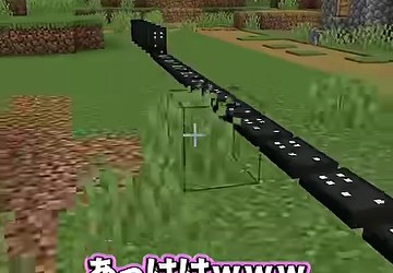 草地の上を黒いドミノの列が奥へ伸びている場面
