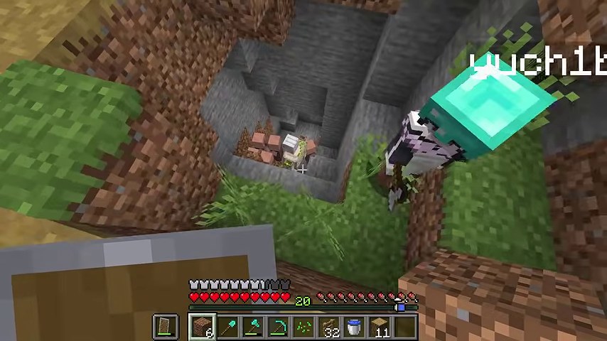 マインクラフトの村でゆうちびさんが穴の縁に立ち、底に村人が見える場面